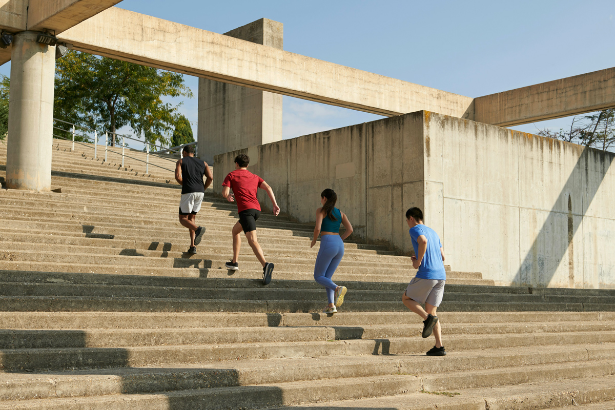 A couple holding hands and walking on a beach